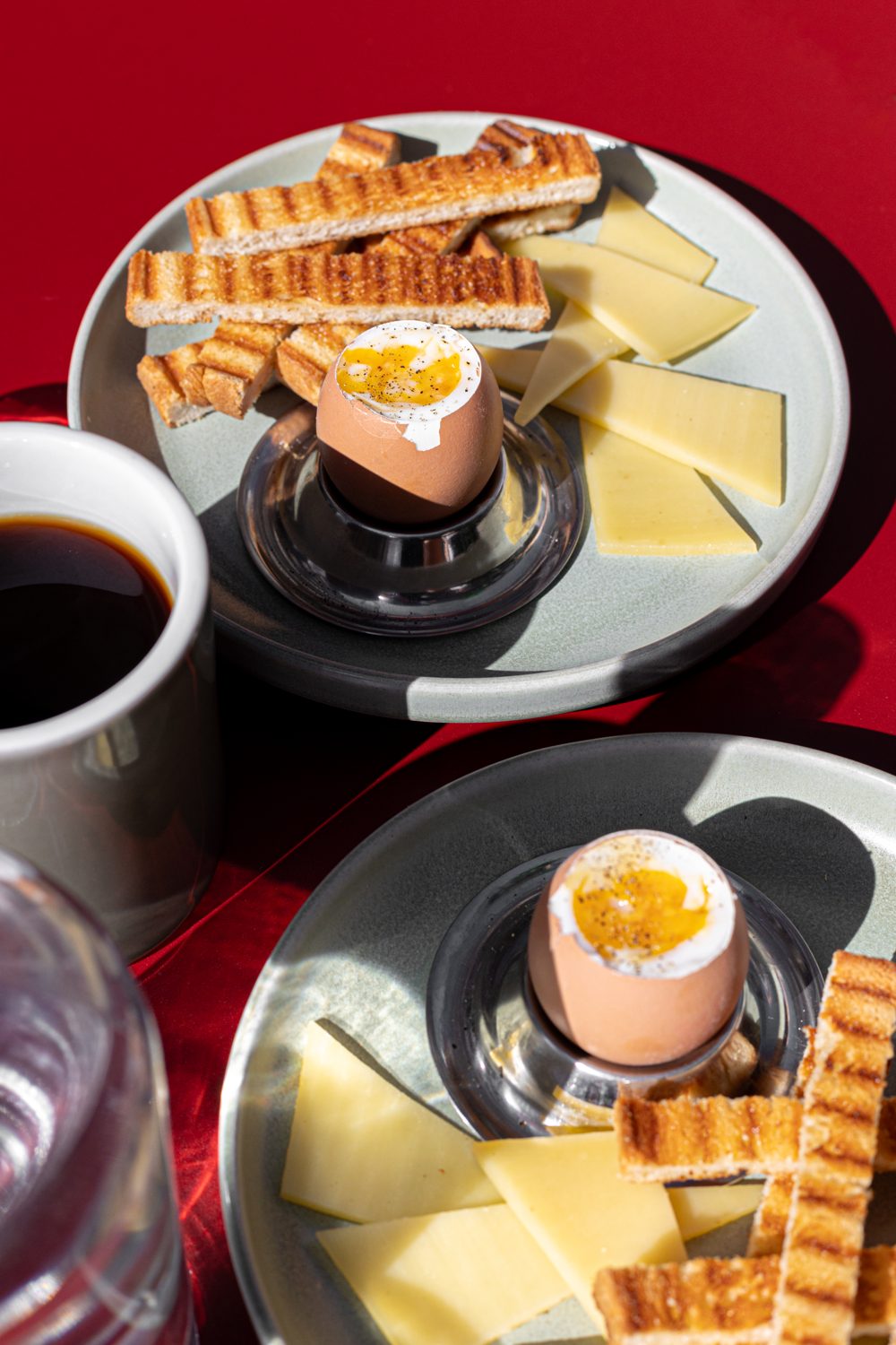 Œuf à la coque, mouillettes et comté sur plateau, café en accompagnement